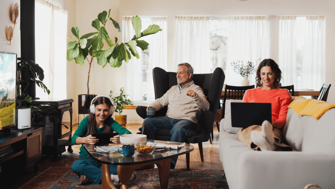 A family gathered on couches in a cozy living room, enjoying each other's company and sharing smiles